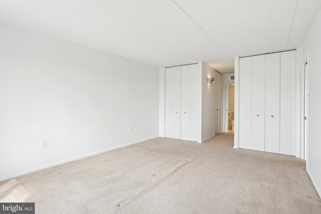 10306 Valley Forge Cir Unit 306, King Of Prussia, PA 19406 - unfurnished bedroom featuring two closets and carpet floors