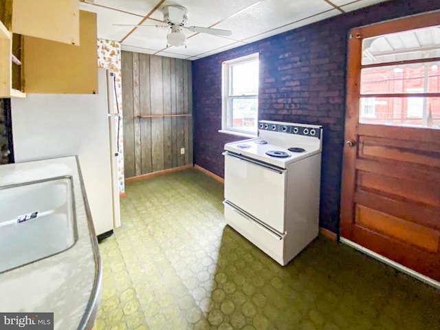 767 Mckean Ave, Donora, PA 15033 - kitchen featuring white appliances, ceiling fan, tile patterned floors, and wood walls