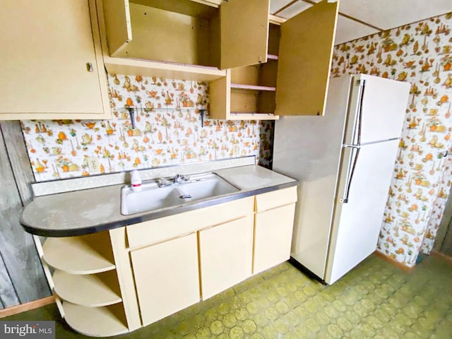 767 Mckean Ave, Donora, PA 15033 - kitchen with open shelves, freestanding refrigerator, wallpapered walls, and white cabinetry