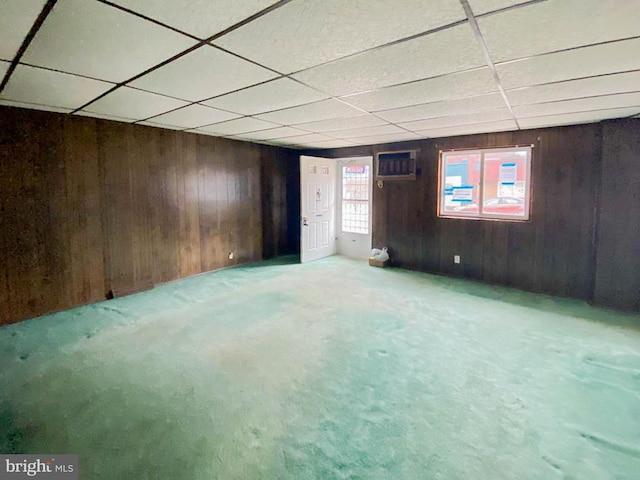 767 Mckean Ave, Donora, PA 15033 - below grade area featuring wooden walls, a paneled ceiling, carpet, and an AC wall unit