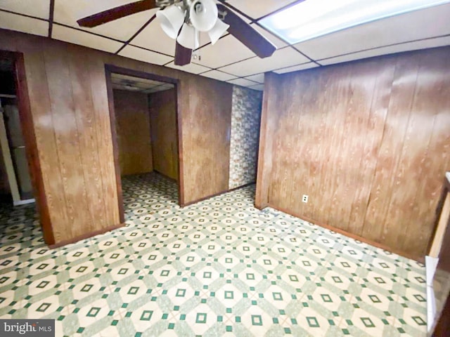 767 Mckean Ave, Donora, PA 15033 - empty room featuring wood walls, a paneled ceiling, and a ceiling fan