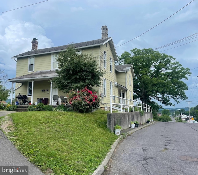 52 Wempe Dr, Cumberland, MD 21502 - view of front of home with a chimney, a front lawn, a porch, and driveway