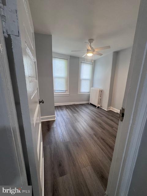 3302 N Palethorp St, Philadelphia, PA 19140 - spare room featuring radiator heating unit, dark wood finished floors, and a ceiling fan