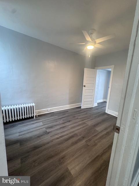 3302 N Palethorp St, Philadelphia, PA 19140 - unfurnished room featuring radiator heating unit, dark wood finished floors, and ceiling fan