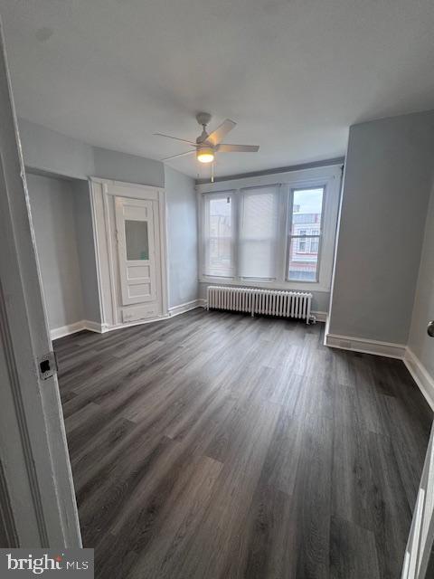 3302 N Palethorp St, Philadelphia, PA 19140 - spare room featuring radiator, ceiling fan, and dark wood-type flooring