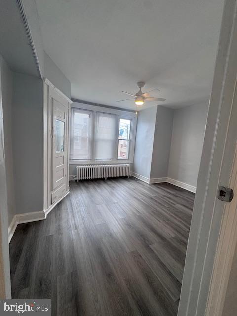 3302 N Palethorp St, Philadelphia, PA 19140 - spare room featuring radiator, dark wood finished floors, and ceiling fan
