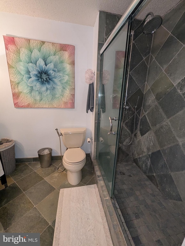 1720 Lake Shore Crest Dr Unit 34, Reston, VA 20190 - bathroom with a stall shower, a textured ceiling, and stone finish floors