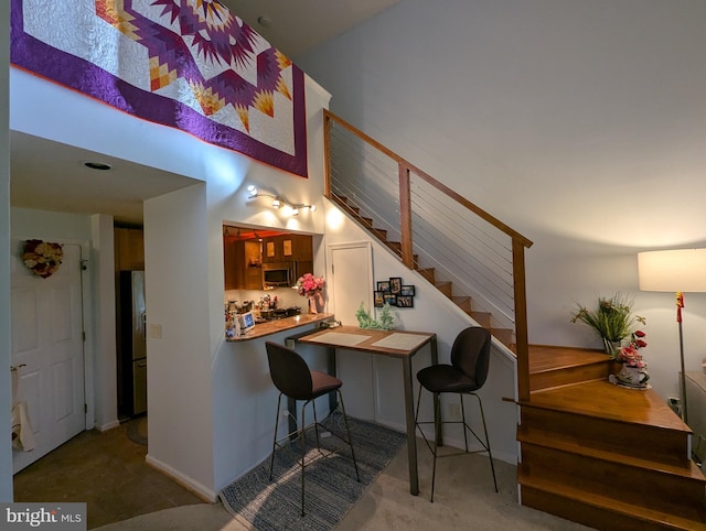 1720 Lake Shore Crest Dr Unit 34, Reston, VA 20190 - kitchen with stainless steel appliances, carpet floors, and a high ceiling