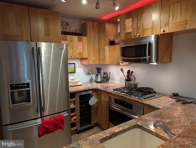1720 Lake Shore Crest Dr Unit 34, Reston, VA 20190 - kitchen with appliances with stainless steel finishes, beverage cooler, stone countertops, light tile patterned floors, and brown cabinets