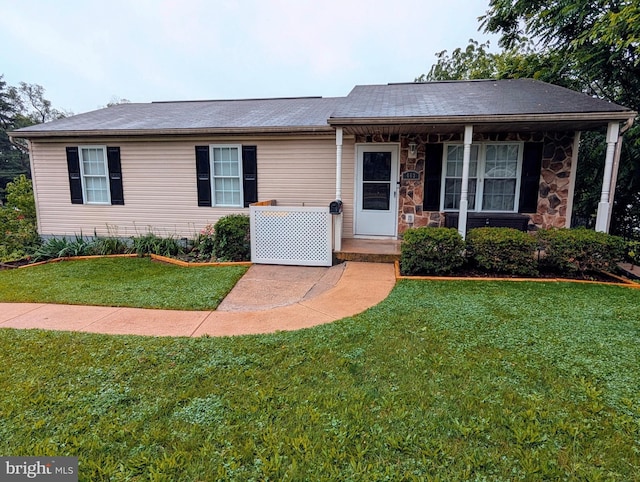 463 Maple St, Manchester, PA 17345 - ranch-style home featuring a front lawn, covered porch, stone siding, and roof with shingles