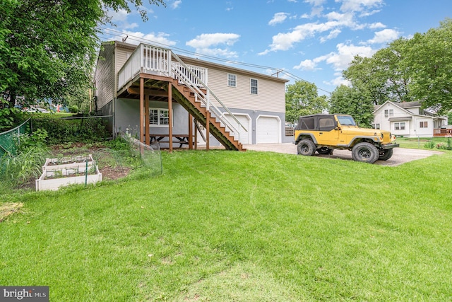 463 Maple St, Manchester, PA 17345 - back of house with stairway, driveway, an attached garage, a vegetable garden, and a deck