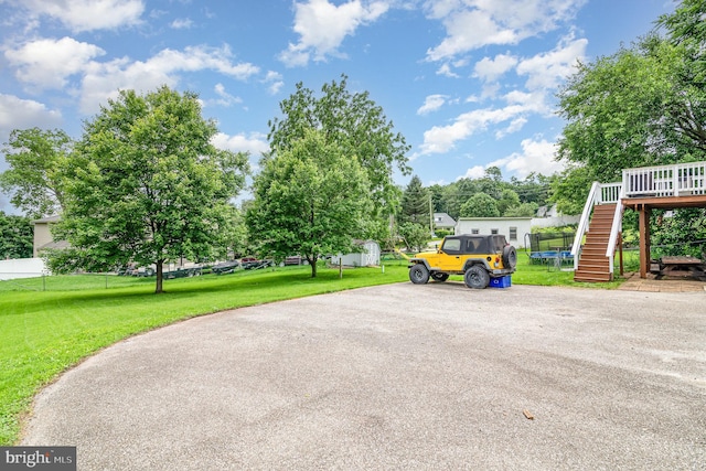 463 Maple St, Manchester, PA 17345 - surrounding community with stairway, a trampoline, and a wooden deck