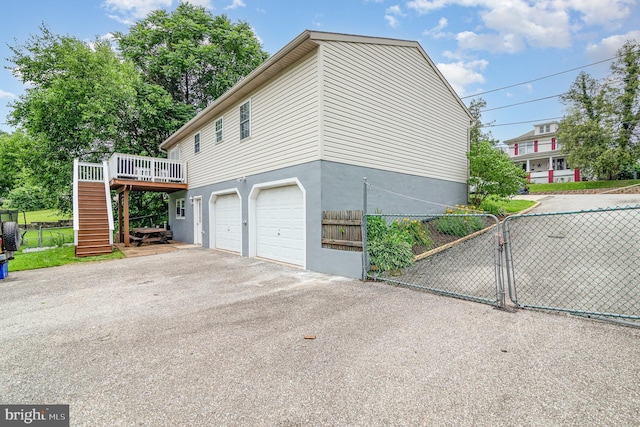 463 Maple St, Manchester, PA 17345 - view of side of property featuring a gate, driveway, stairs, a garage, and a deck