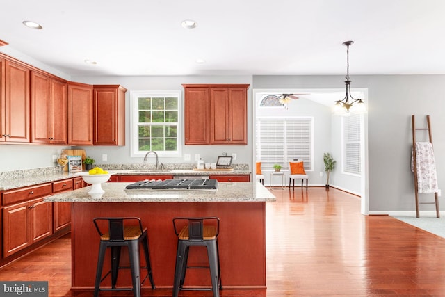173 Empress Alexandra Pl, Fredericksburg, VA 22406 - kitchen featuring a kitchen island, a kitchen bar, wood finished floors, hanging light fixtures, and recessed lighting