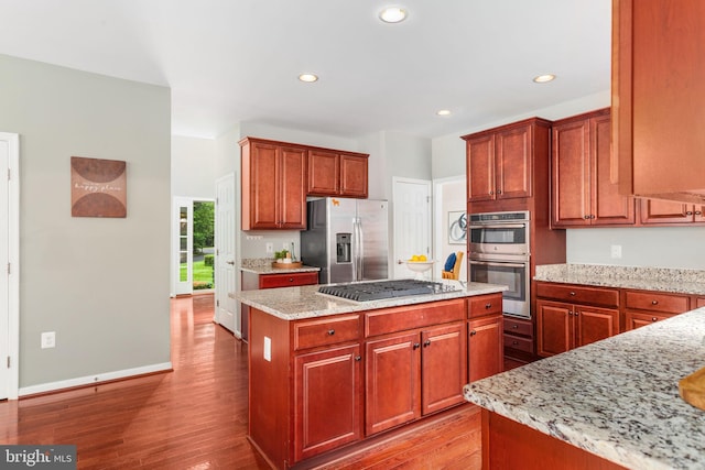 173 Empress Alexandra Pl, Fredericksburg, VA 22406 - kitchen with stainless steel appliances, light wood-style flooring, a kitchen island, light stone counters, and recessed lighting