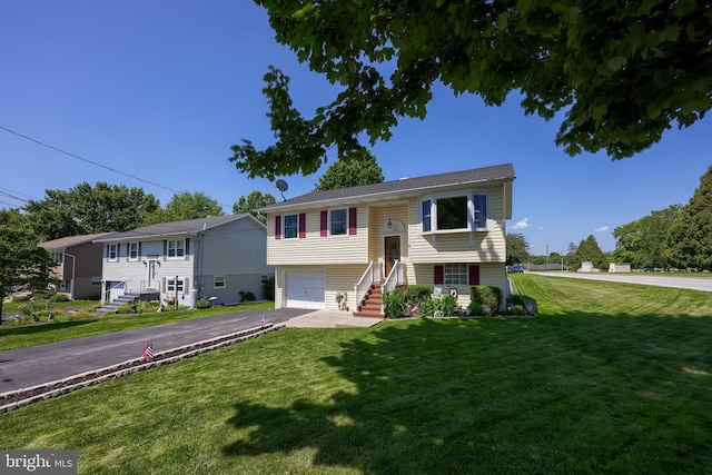 1 Sherman St, Hanover, PA 17331 - bi-level home with asphalt driveway, a front yard, an attached garage, and stairway