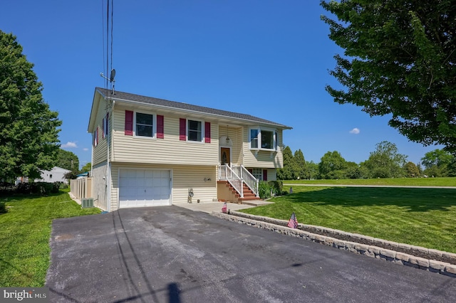 1 Sherman St, Hanover, PA 17331 - split foyer home featuring driveway, a front yard, and a garage