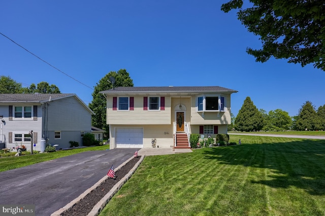 1 Sherman St, Hanover, PA 17331 - raised ranch featuring asphalt driveway, a front lawn, and an attached garage