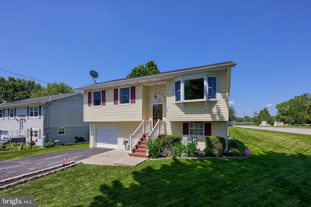1 Sherman St, Hanover, PA 17331 - bi-level home featuring asphalt driveway, a front yard, and a garage