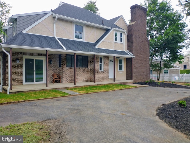 512 Mifflin Blvd, Reading, PA 19607 - view of front of property featuring a chimney, a porch, stucco siding, and roof with shingles