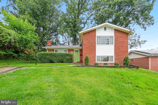 804 Gregorio Dr, Silver Spring, MD 20901 - split level home with brick siding, a front yard, and a chimney