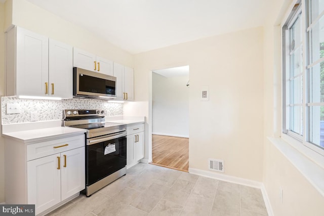 804 Gregorio Dr, Silver Spring, MD 20901 - kitchen with stainless steel appliances, tasteful backsplash, white cabinets, and light countertops