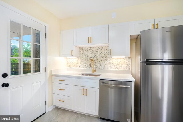 804 Gregorio Dr, Silver Spring, MD 20901 - kitchen featuring appliances with stainless steel finishes, light countertops, tasteful backsplash, and white cabinets