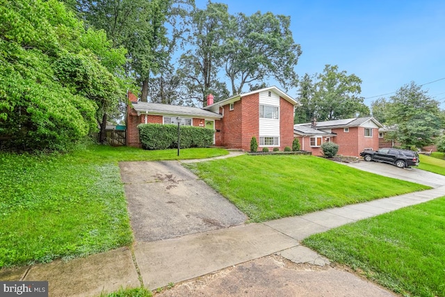 804 Gregorio Dr, Silver Spring, MD 20901 - split level home with brick siding, a front lawn, and a chimney