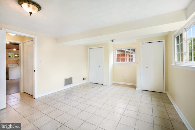 804 Gregorio Dr, Silver Spring, MD 20901 - unfurnished bedroom with multiple closets, washer / clothes dryer, and light tile patterned floors