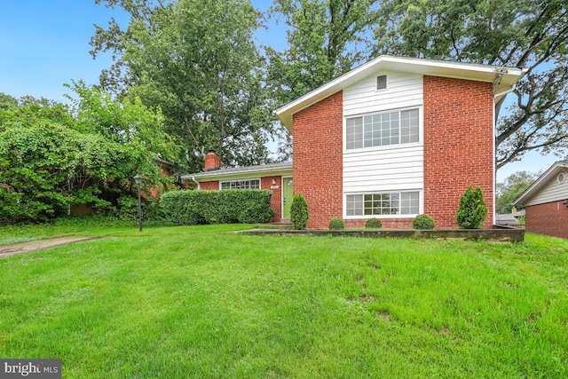 804 Gregorio Dr, Silver Spring, MD 20901 - view of front of home featuring brick siding, a front yard, and a chimney