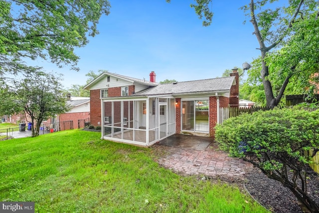 804 Gregorio Dr, Silver Spring, MD 20901 - back of property with a sunroom, a chimney, brick siding, a patio, and a shingled roof