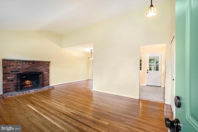 804 Gregorio Dr, Silver Spring, MD 20901 - unfurnished living room with vaulted ceiling, wood finished floors, and a fireplace
