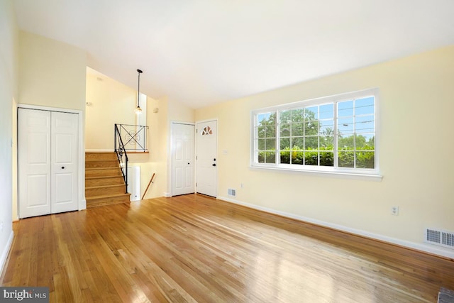 804 Gregorio Dr, Silver Spring, MD 20901 - unfurnished living room with wood finished floors, lofted ceiling, and stairs