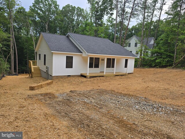 728 Meadow Dr, Tappahannock, VA 22560 - view of front facade featuring crawl space, roof with shingles, covered porch, and view of scattered trees