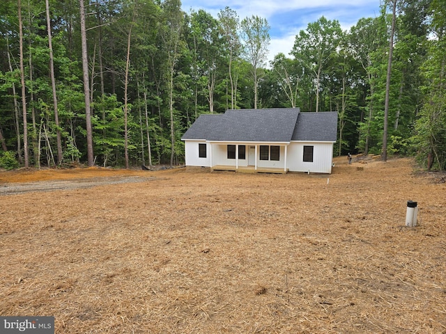 728 Meadow Dr, Tappahannock, VA 22560 - view of front of home featuring roof with shingles and a forest view