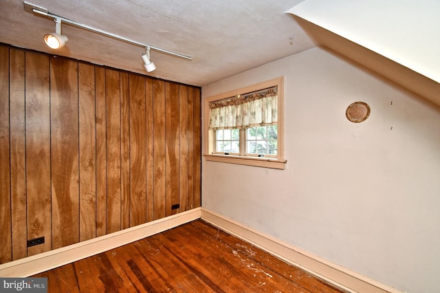 2228 Hillthorpe Ave, Abington, PA 19001 - empty room with hardwood / wood-style flooring, rail lighting, wooden walls, and lofted ceiling
