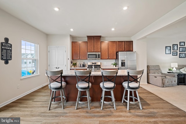 213 Dalton, Woolwich Twp, NJ 08085 - kitchen with appliances with stainless steel finishes, open floor plan, an island with sink, recessed lighting, and brown cabinets