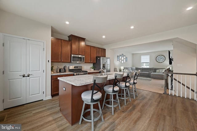 213 Dalton, Woolwich Twp, NJ 08085 - kitchen with stainless steel appliances, wood finished floors, a center island with sink, light countertops, and open floor plan