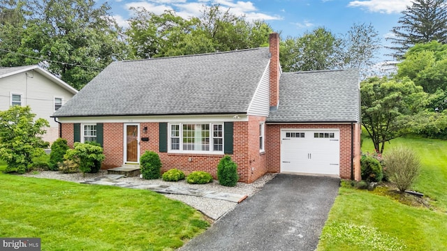 310 E Charlotte St, Millersville, PA 17551 - new england style home featuring an attached garage, a chimney, asphalt driveway, brick siding, and a front yard