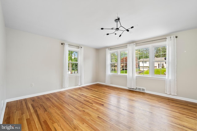 310 E Charlotte St, Millersville, PA 17551 - spare room featuring plenty of natural light, a chandelier, and light wood finished floors