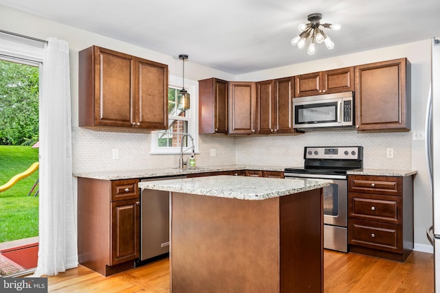 310 E Charlotte St, Millersville, PA 17551 - kitchen with stainless steel appliances, backsplash, decorative light fixtures, and a kitchen island
