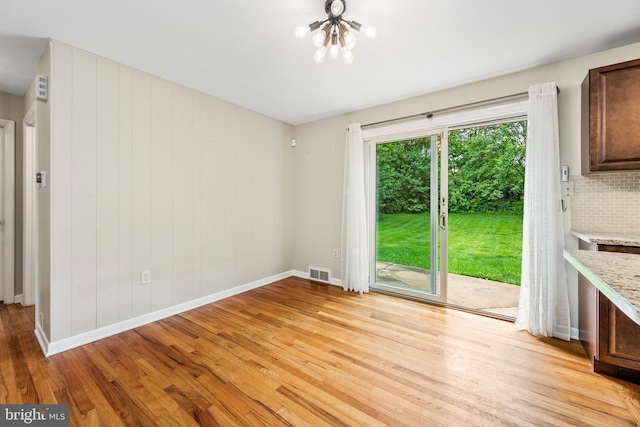 310 E Charlotte St, Millersville, PA 17551 - unfurnished dining area with light wood-style flooring and a chandelier