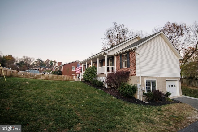 110 Jamestown Rd, Front Royal, VA 22630 - view of side of home with brick siding, a garage, covered porch, and driveway