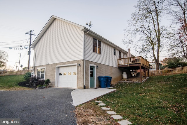 110 Jamestown Rd, Front Royal, VA 22630 - view of side of property featuring brick siding, a wooden deck, a garage, and asphalt driveway