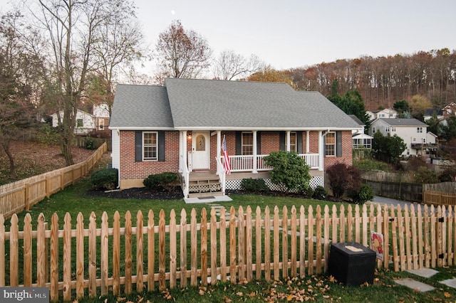 110 Jamestown Rd, Front Royal, VA 22630 - view of front of house with covered porch, brick siding, and a fenced front yard