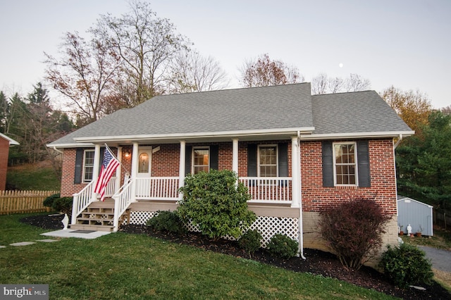 110 Jamestown Rd, Front Royal, VA 22630 - view of front facade with a porch, brick siding, a shingled roof, and a storage shed