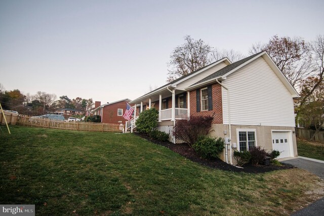110 Jamestown Rd, Front Royal, VA 22630 - view of side of home with brick siding, a garage, covered porch, and driveway
