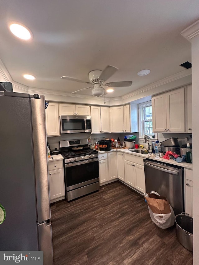 958 Middleborough, Baltimore, MD 21221 - kitchen with appliances with stainless steel finishes, dark wood-style flooring, crown molding, light countertops, and white cabinets