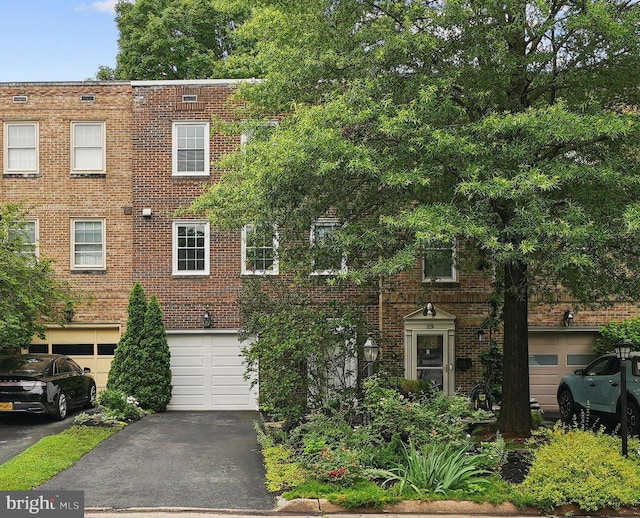 121 Harrison St NE, Leesburg, VA 20176 - view of front of house with driveway, an attached garage, and brick siding