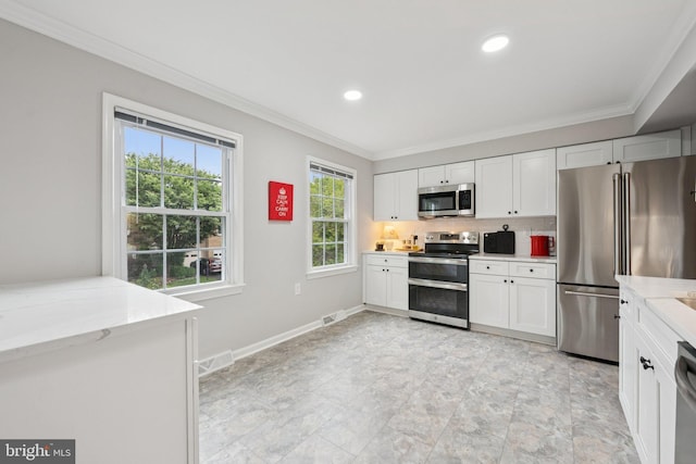 121 Harrison St NE, Leesburg, VA 20176 - kitchen featuring stainless steel appliances, crown molding, white cabinetry, tasteful backsplash, and light stone counters